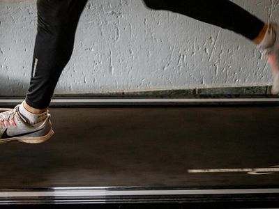 Blurred motion of an athlete running on a treadmill.