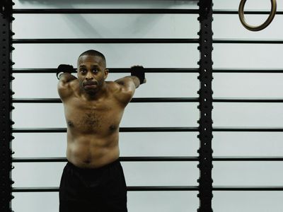 Man hands holding a bar during intense training session.