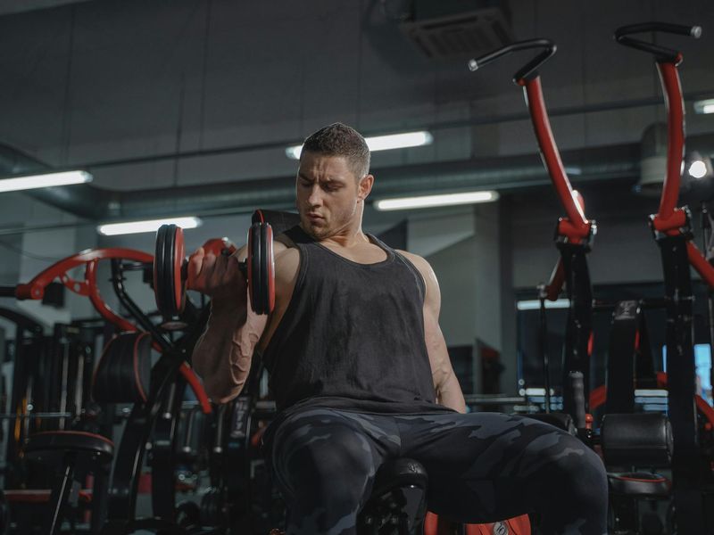 Strong man lifting weights in a industrial style gym.